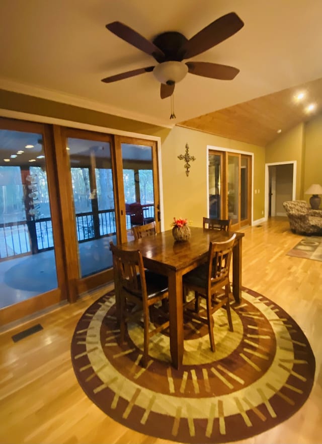 dining room featuring ornamental molding, hardwood / wood-style flooring, ceiling fan, and lofted ceiling