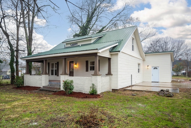 view of front of home with a front lawn and a porch