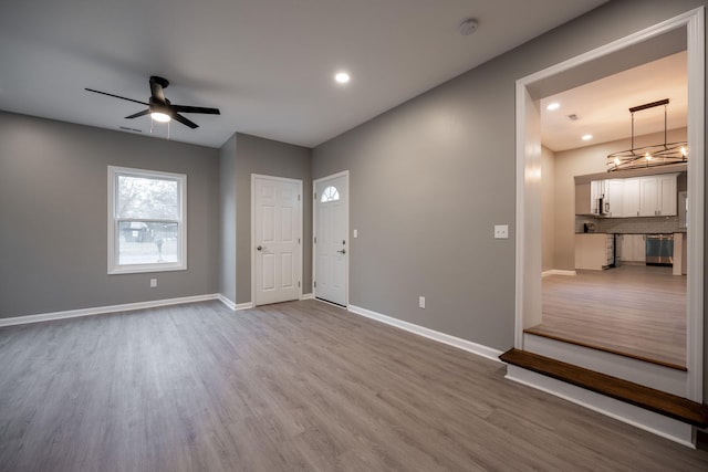 unfurnished room with wood-type flooring and ceiling fan