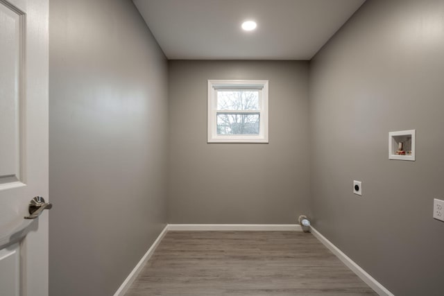 laundry area with electric dryer hookup, washer hookup, and light wood-type flooring