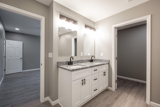 bathroom with vanity and wood-type flooring