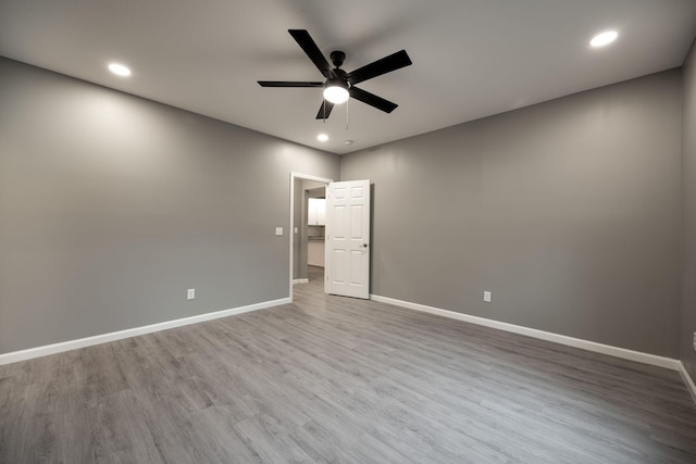 spare room with hardwood / wood-style floors and ceiling fan