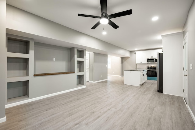 unfurnished living room with ceiling fan and light wood-type flooring