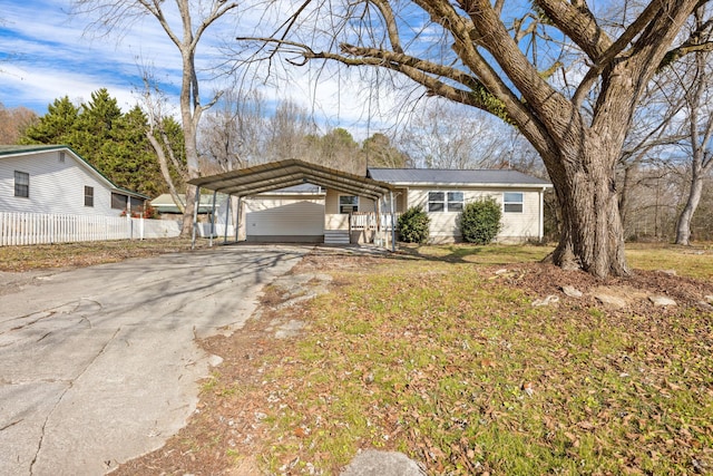 single story home with a front lawn and a carport