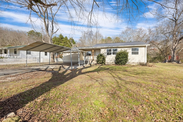 view of front facade with a front yard, a porch, and a carport