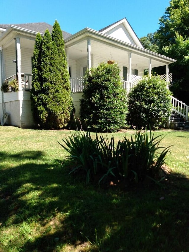 view of side of property with a lawn