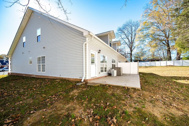 rear view of property featuring a patio area and a yard