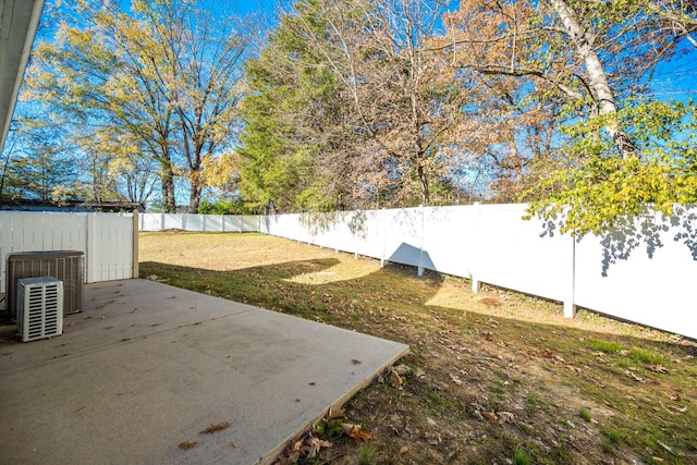 view of yard featuring central air condition unit and a patio