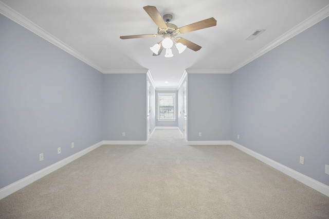 empty room featuring ceiling fan, crown molding, and light carpet