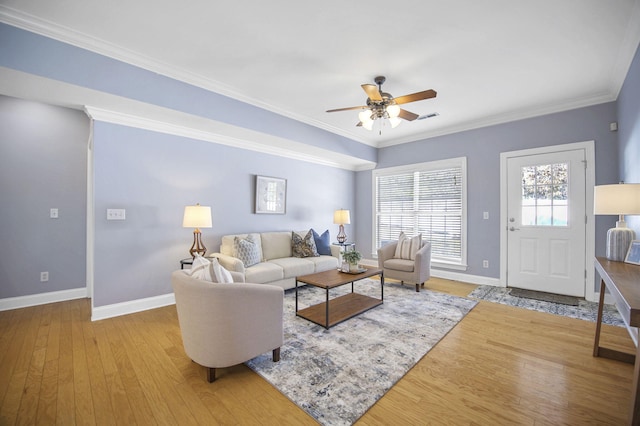 living room with light hardwood / wood-style flooring, ceiling fan, and crown molding