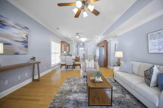 living room with light hardwood / wood-style flooring, ornate columns, ceiling fan, and crown molding