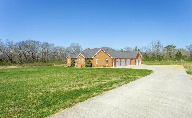 ranch-style house with a front yard and a garage