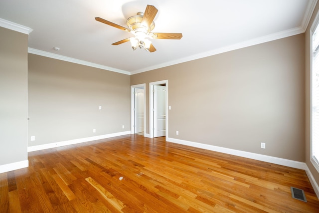 empty room with light wood-type flooring, ceiling fan, and crown molding