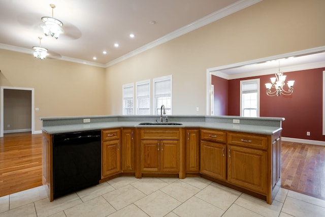 kitchen featuring light wood-type flooring, ornamental molding, a kitchen island with sink, sink, and dishwasher