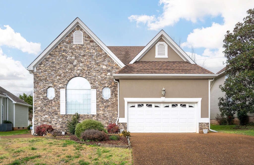 view of front of home with a garage and a front lawn