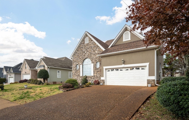 front of property with a garage and a front lawn