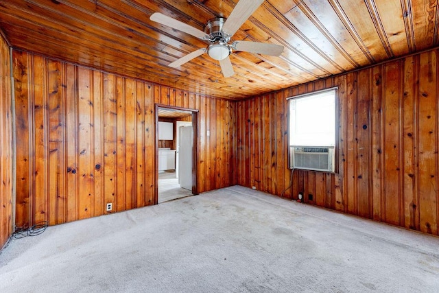 spare room with light colored carpet, ceiling fan, wooden ceiling, and wood walls