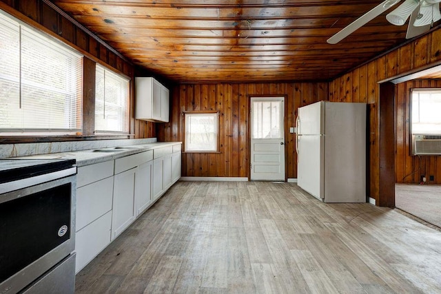 kitchen featuring light hardwood / wood-style floors, white cabinetry, a healthy amount of sunlight, and white refrigerator