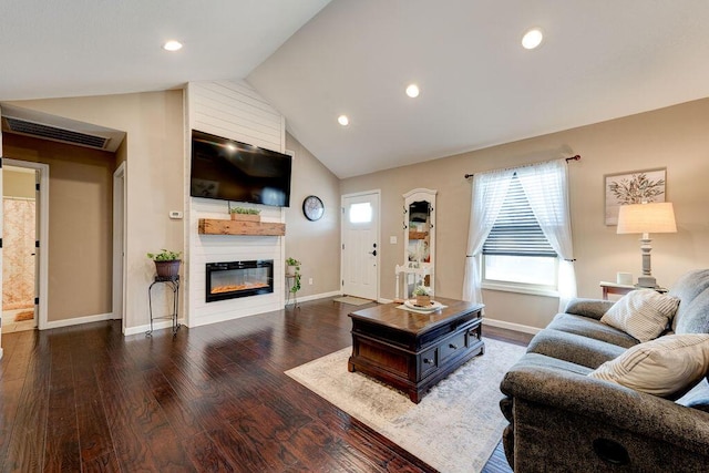 living room with lofted ceiling, a fireplace, and dark wood-type flooring