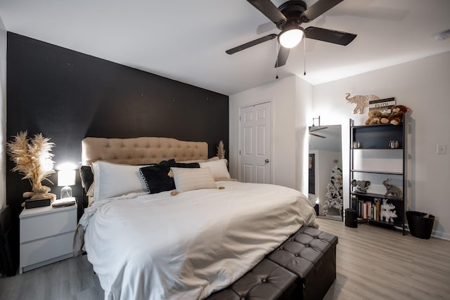 bedroom with light hardwood / wood-style flooring and ceiling fan