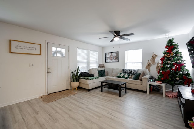 living room featuring light wood-type flooring and ceiling fan