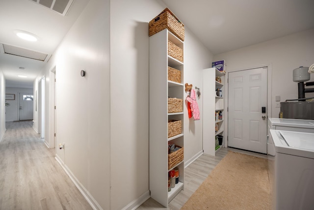 interior space featuring washing machine and dryer and light hardwood / wood-style floors