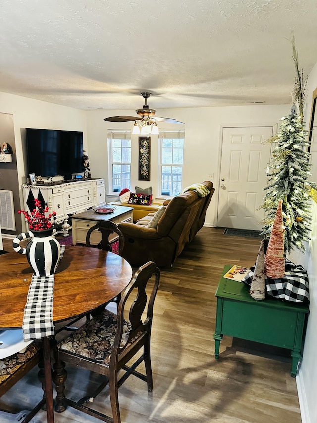 dining space with hardwood / wood-style floors, a textured ceiling, and ceiling fan