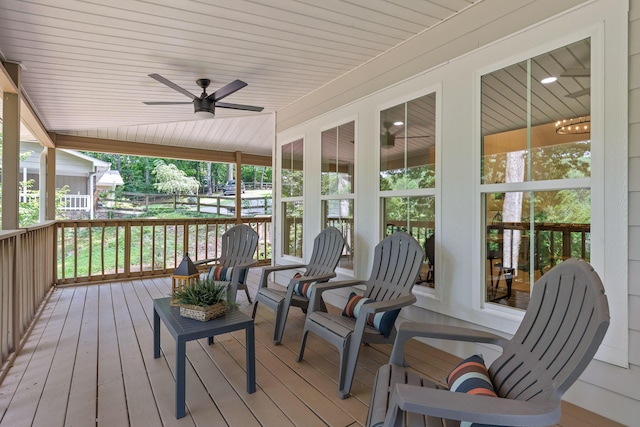 wooden terrace featuring a ceiling fan