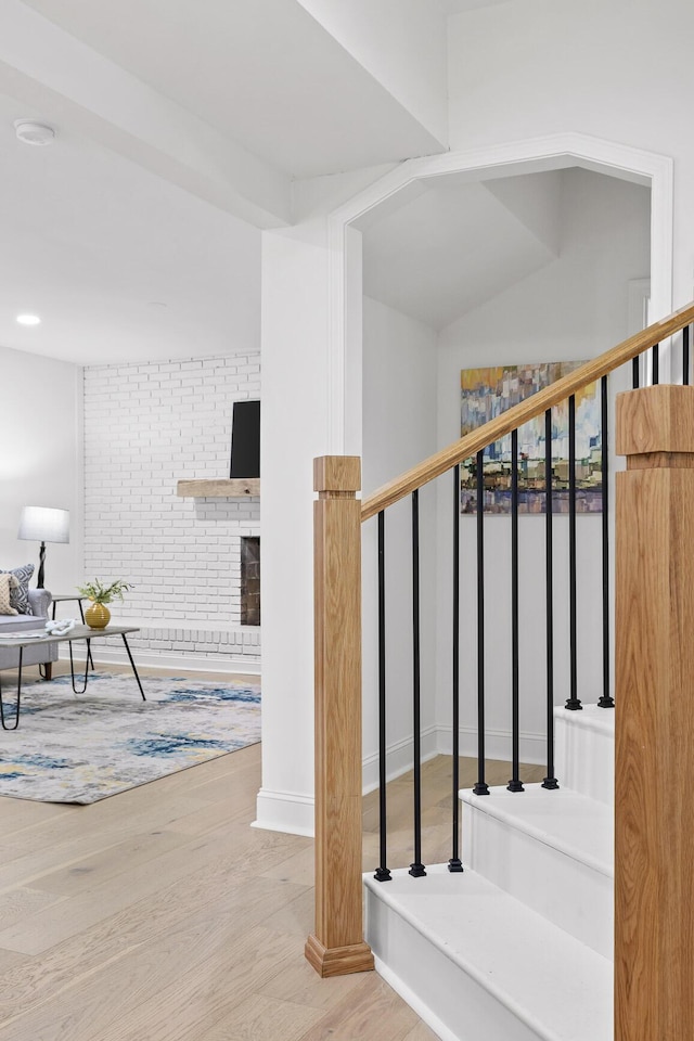 stairway featuring baseboards and wood finished floors