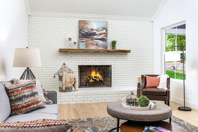 living area featuring crown molding, wood finished floors, and a healthy amount of sunlight