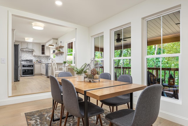 dining room featuring light wood-style flooring and baseboards