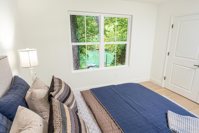 bedroom featuring baseboards and wood finished floors