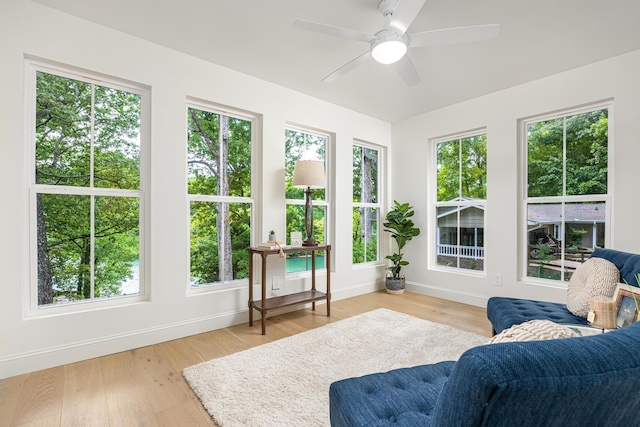 sunroom with a healthy amount of sunlight and ceiling fan