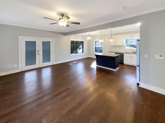 kitchen featuring white cabinetry, a center island, dark hardwood / wood-style flooring, decorative light fixtures, and appliances with stainless steel finishes