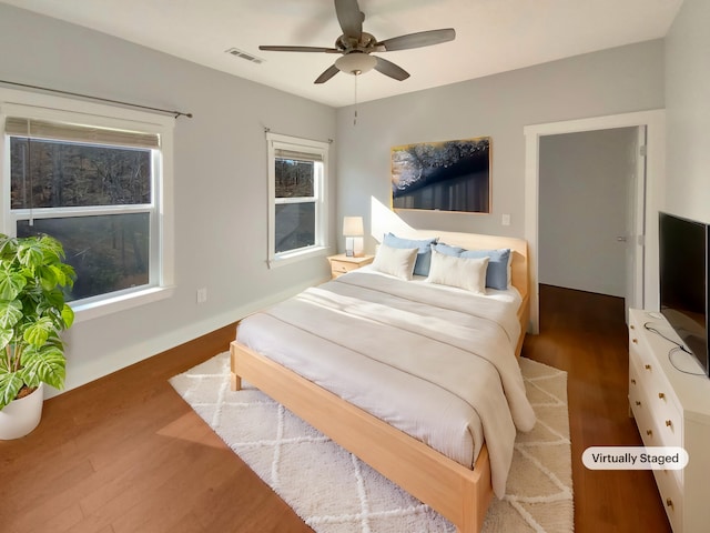 bedroom with ceiling fan and dark wood-type flooring