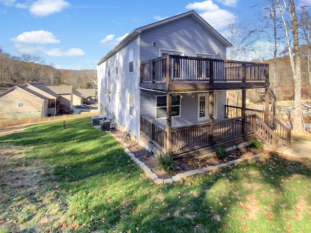 rear view of property with a lawn and a deck