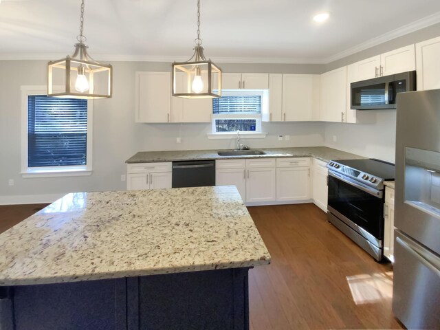 9693 W Ridge Trail Rd, Soddy Daisy, TN 37379 - kitchen with appliances with stainless steel finishes, a sink, crown molding, light stone counters, and a center island