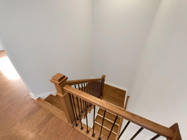 stairs with hardwood / wood-style floors