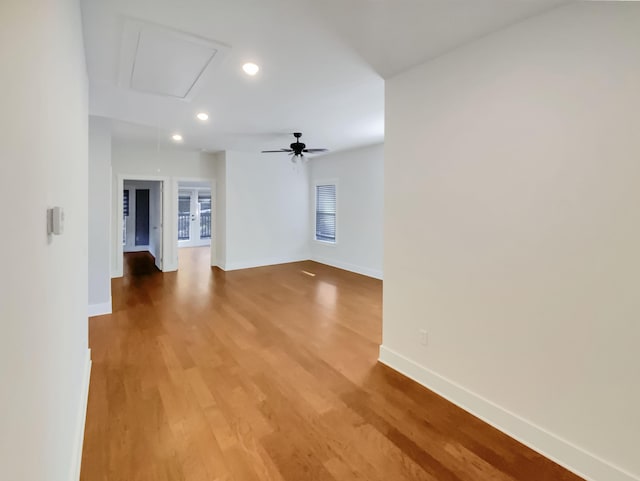 empty room with hardwood / wood-style floors and ceiling fan