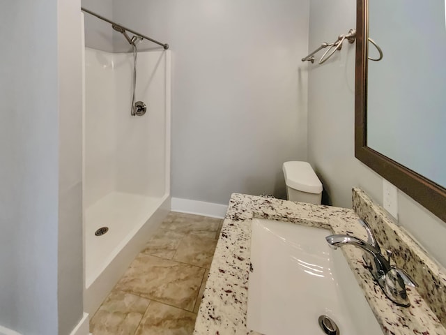 bathroom with a shower, sink, and toilet