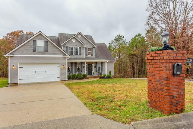 425 Wildewood Trl, Chickamauga, GA 30707 - view of front of home with concrete driveway, a front lawn, and covered porch