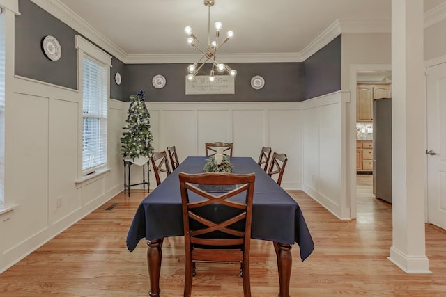 425 Wildewood Trl, Chickamauga, GA 30707 - dining space with a decorative wall, light wood finished floors, a chandelier, and crown molding