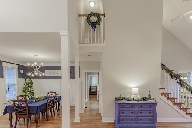 425 Wildewood Trl, Chickamauga, GA 30707 - interior space with ornamental molding, a wainscoted wall, a chandelier, a high ceiling, and wood finished floors