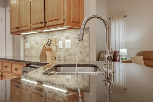 425 Wildewood Trl, Chickamauga, GA 30707 - kitchen with a sink, backsplash, dark stone counters, and light brown cabinets