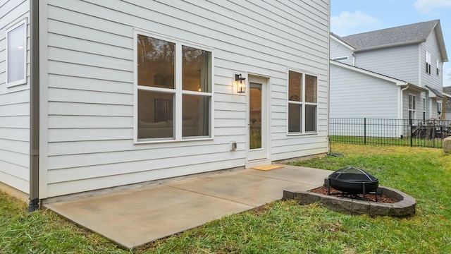 exterior space with an outdoor fire pit and a lawn