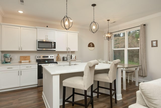 kitchen with a kitchen island with sink, decorative light fixtures, dark hardwood / wood-style flooring, white cabinetry, and stainless steel appliances