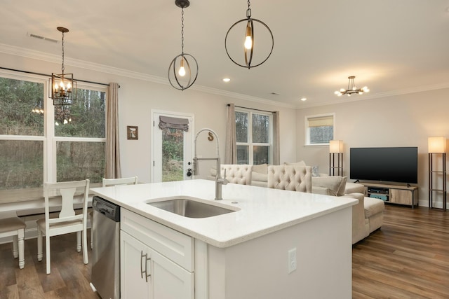 kitchen with a kitchen island with sink, sink, hanging light fixtures, stainless steel dishwasher, and white cabinetry