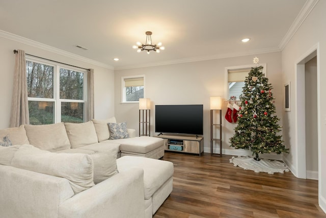 living room with dark hardwood / wood-style flooring, ornamental molding, and an inviting chandelier