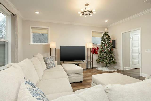 living room with crown molding, dark wood-type flooring, and a chandelier