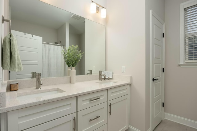 bathroom featuring tile patterned floors, vanity, and a shower with curtain